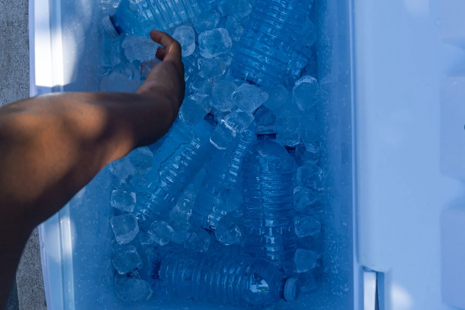 Open cooler filled with ice and bottles of water