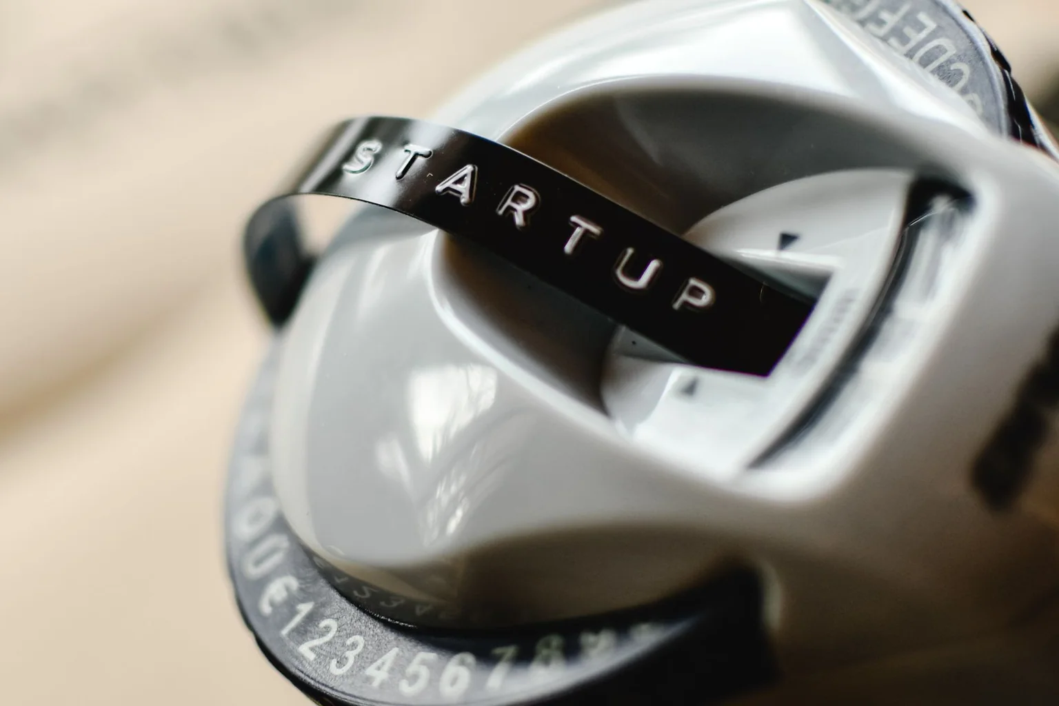 Close-up of a handheld label maker printing a startup label