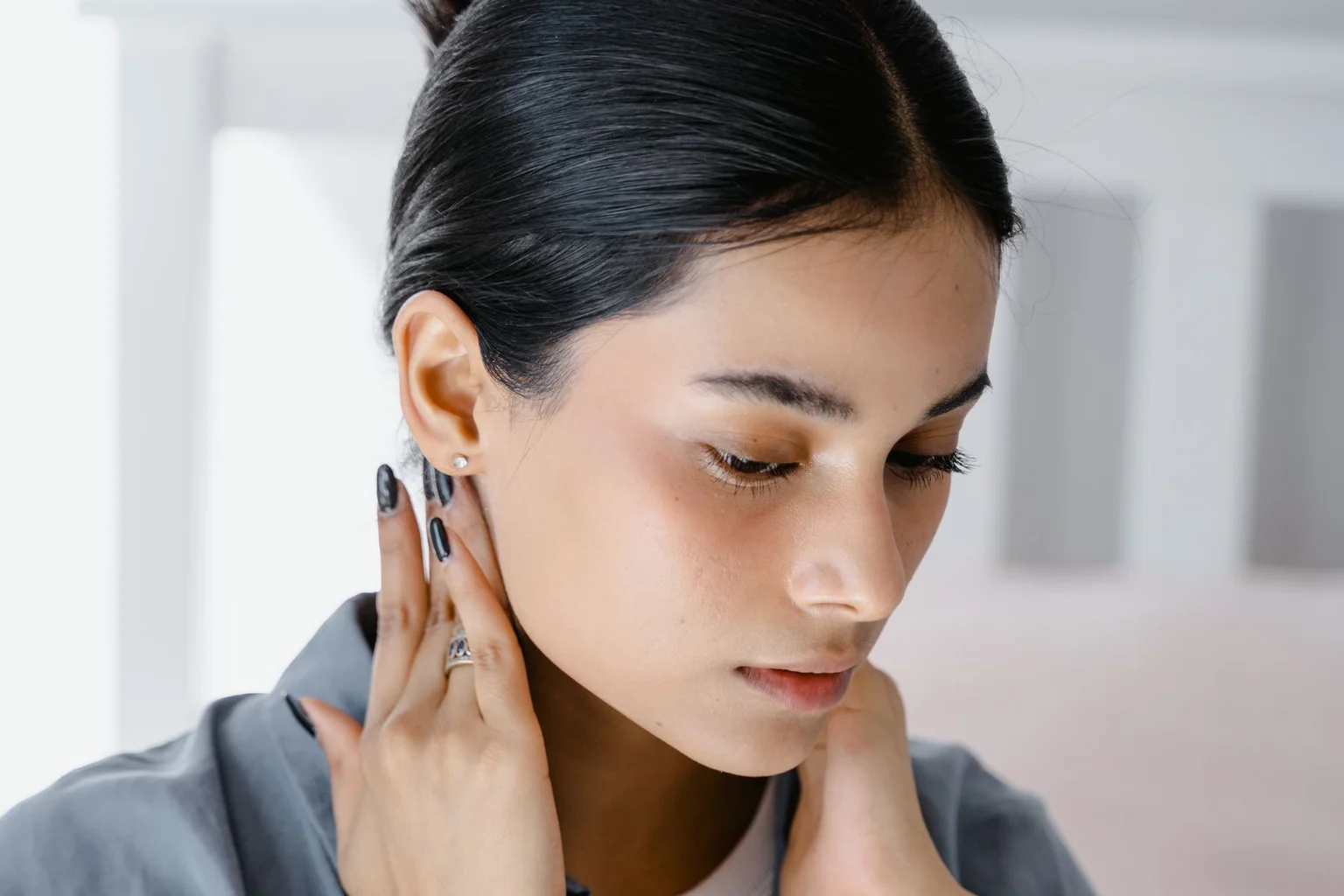 Person gently massaging the side of their neck