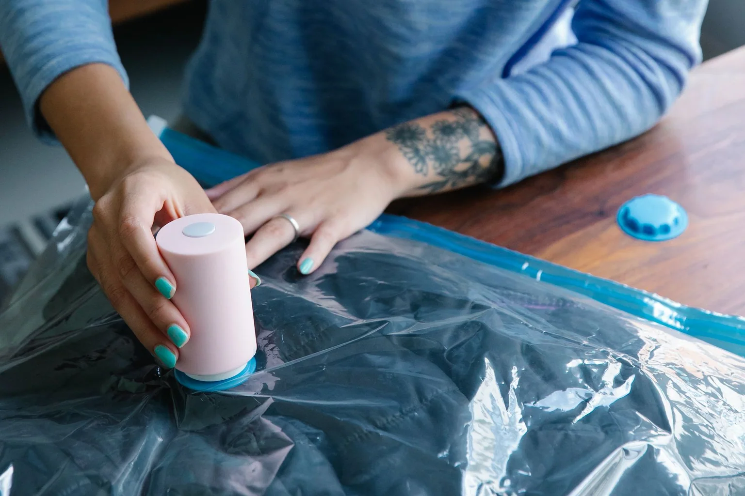Clothing being compressed inside a vacuum storage bag